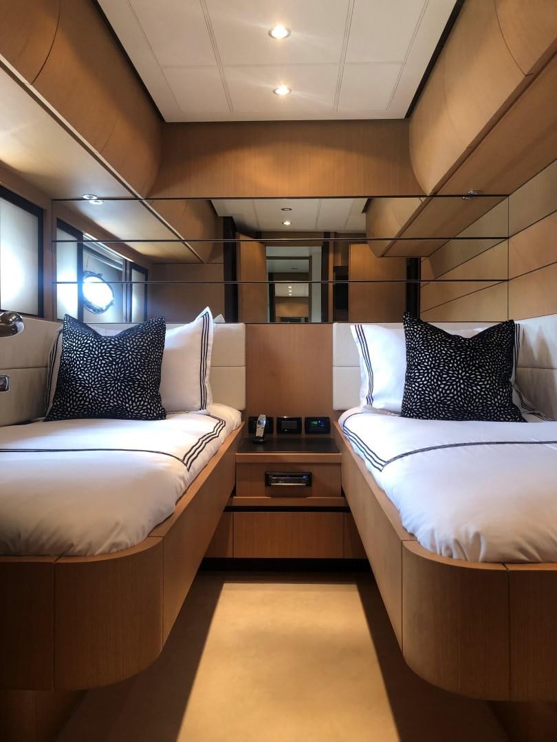 a room with a bed and a desk aboard YCM 90 Yacht for Sale