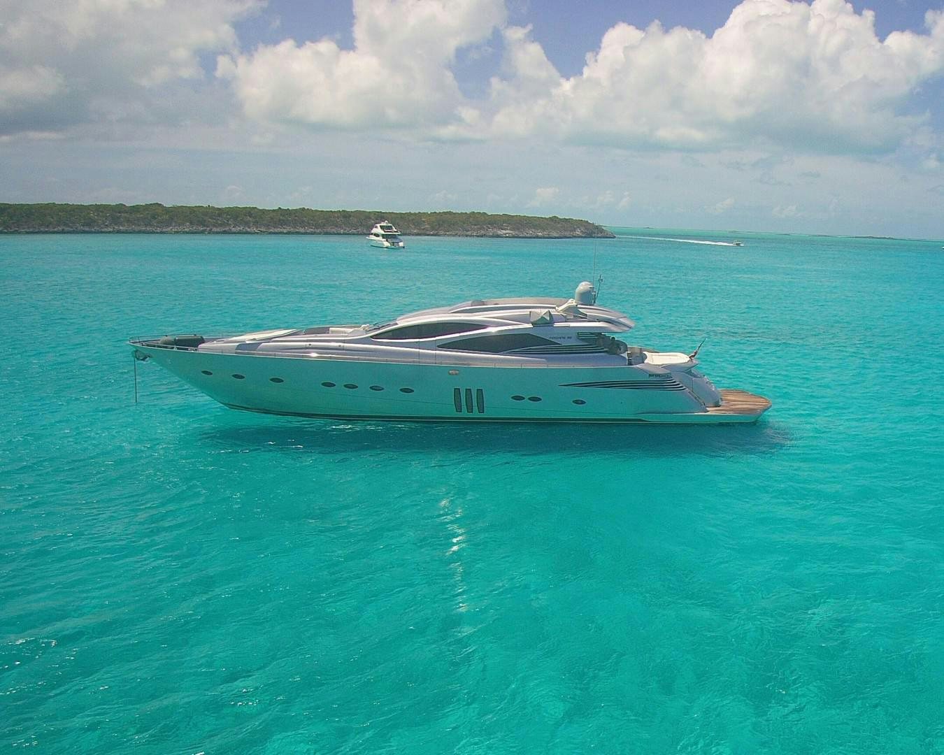 a boat in the water with Lady Musgrave Island in the background aboard YCM 90 Yacht for Sale