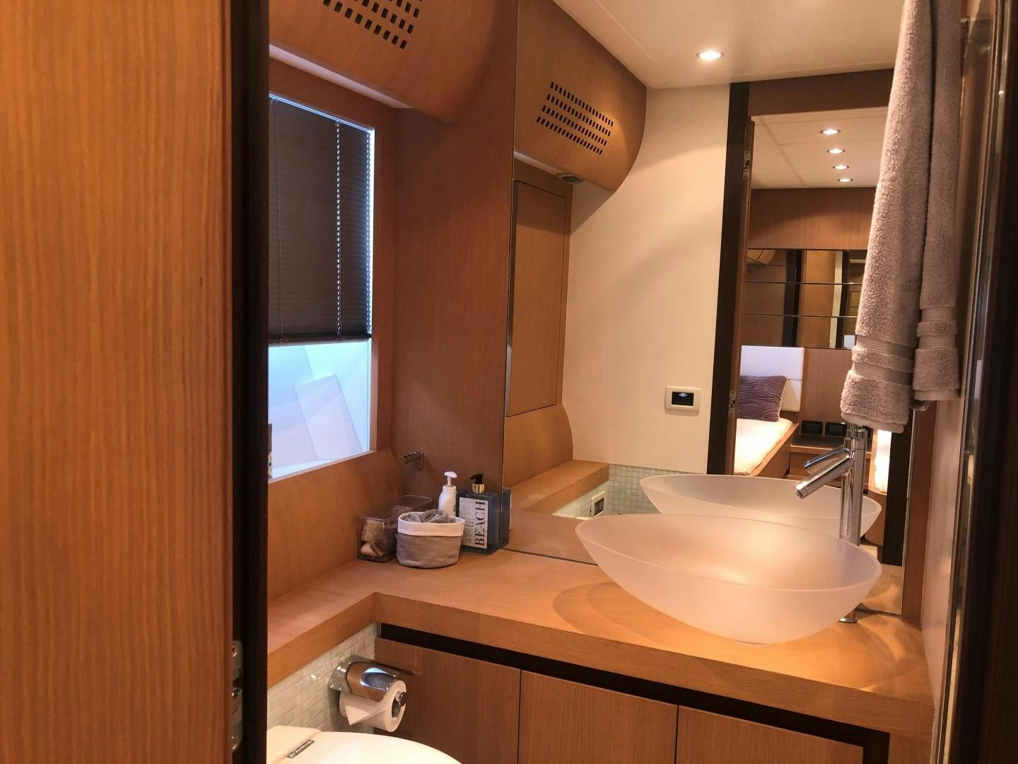 a bathroom with a sink and a mirror aboard YCM 90 Yacht for Sale