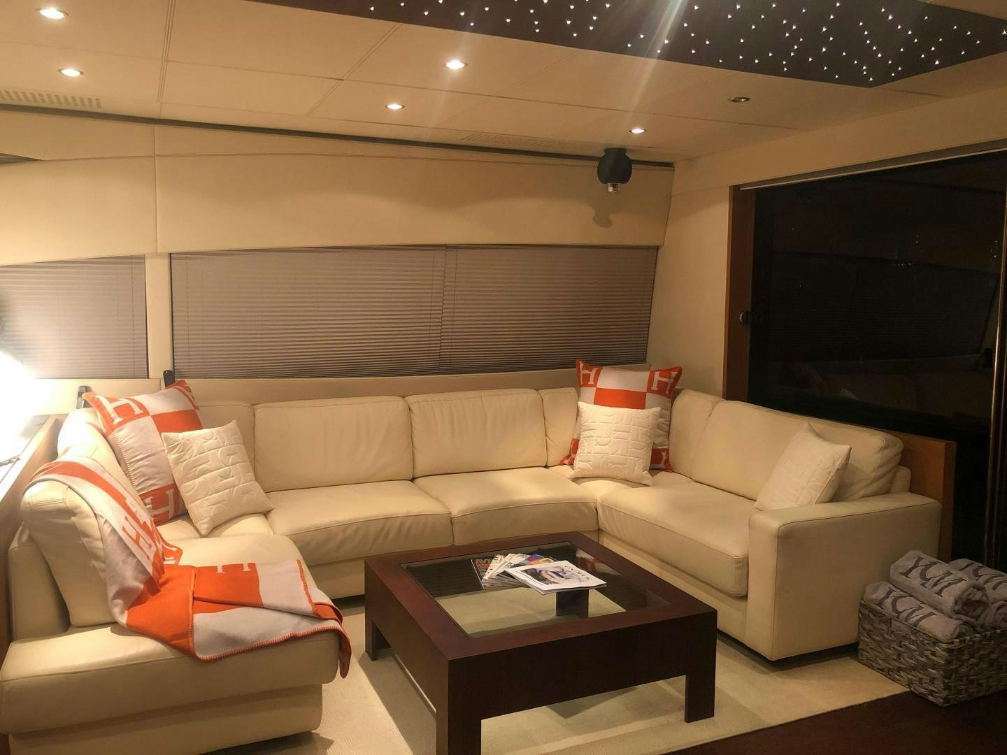 a living room with a couch and a television aboard YCM 90 Yacht for Sale