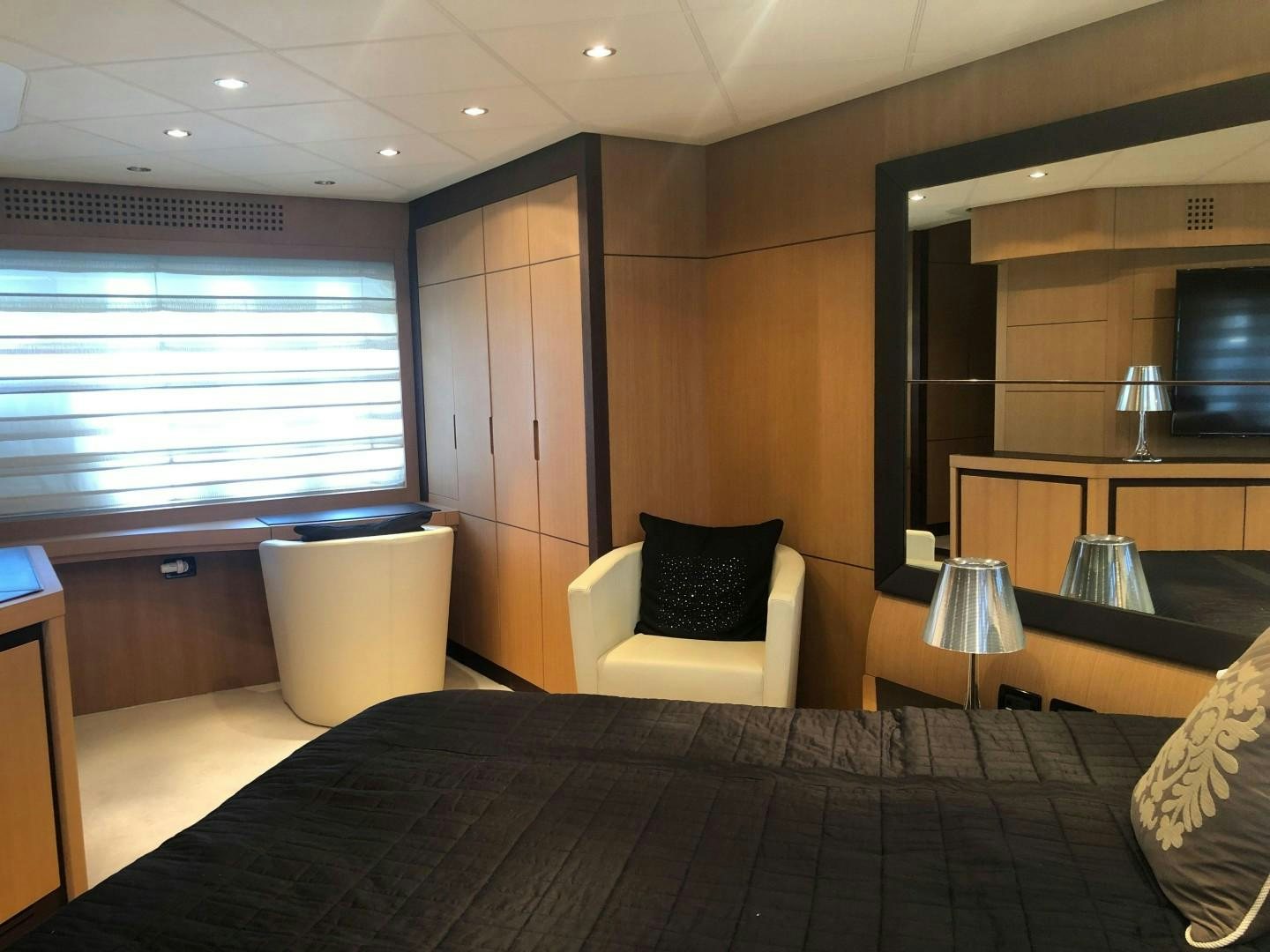 a hotel room with a bed and a desk aboard YCM 90 Yacht for Sale