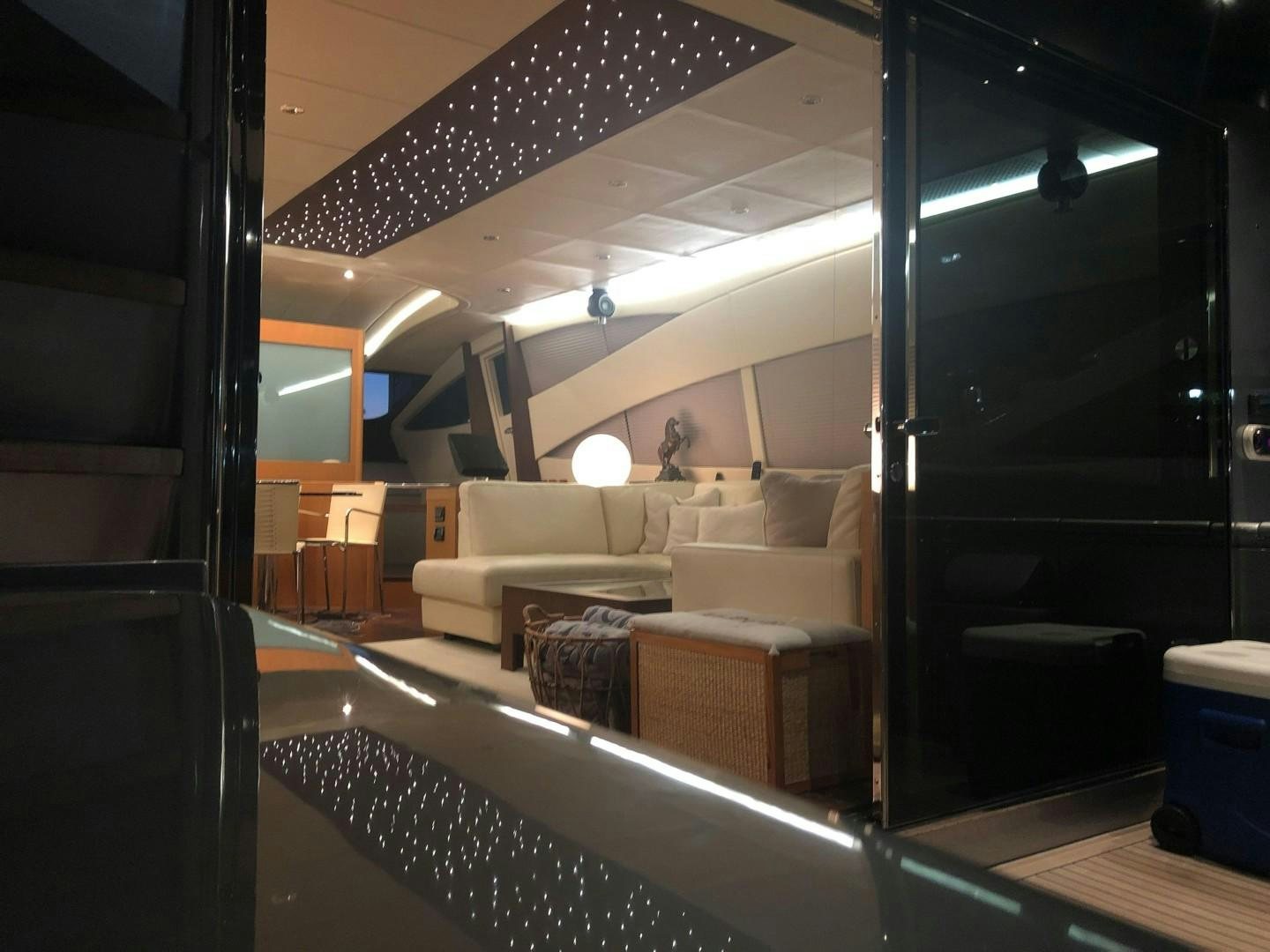 a room with a couch and a table aboard YCM 90 Yacht for Sale