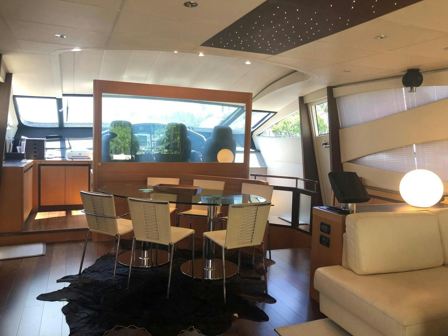 a room with a table and chairs aboard YCM 90 Yacht for Sale