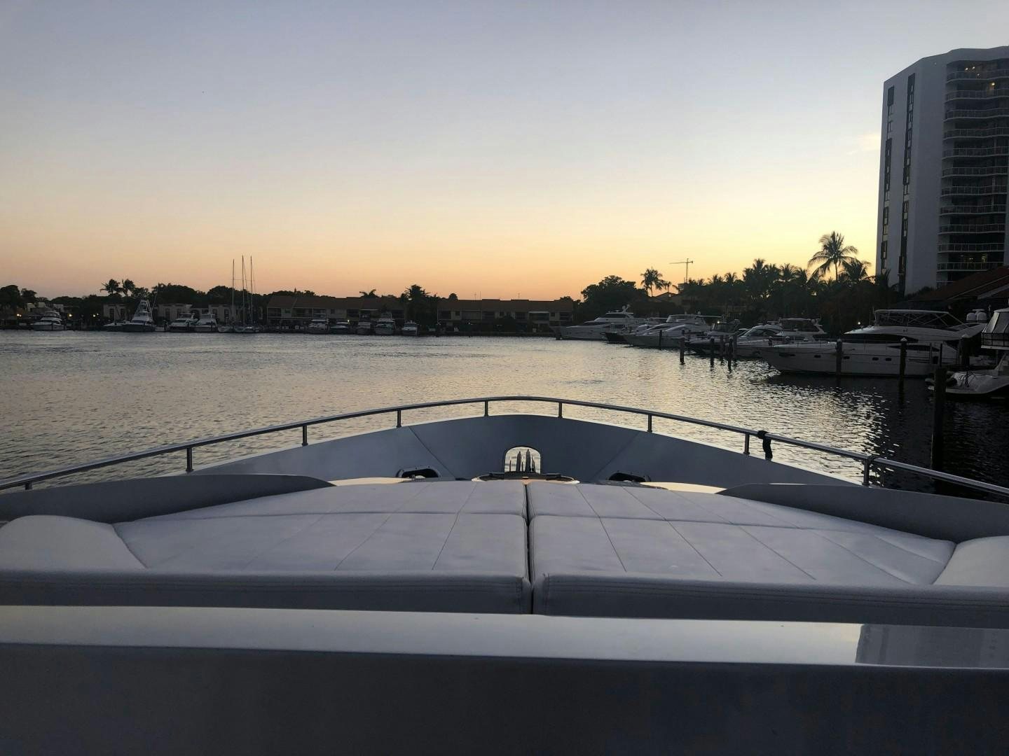 a body of water with boats in it and buildings in the background aboard YCM 90 Yacht for Sale