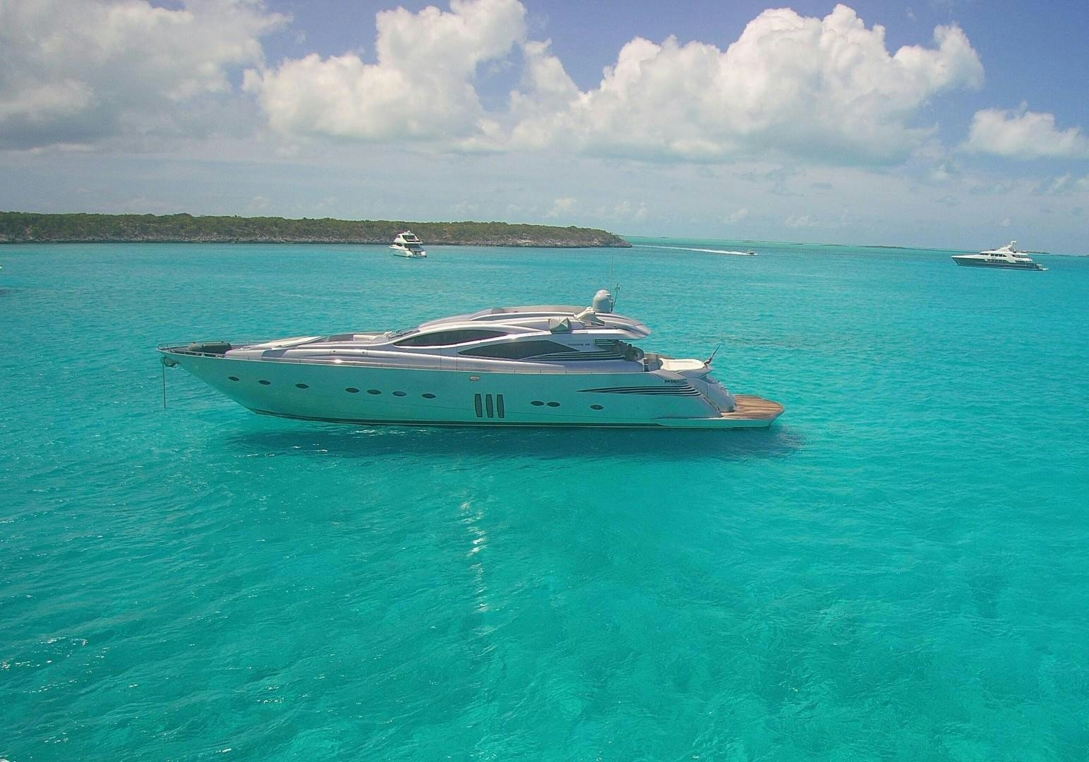 a boat in the water with Lady Musgrave Island in the background aboard YCM 90 Yacht for Sale