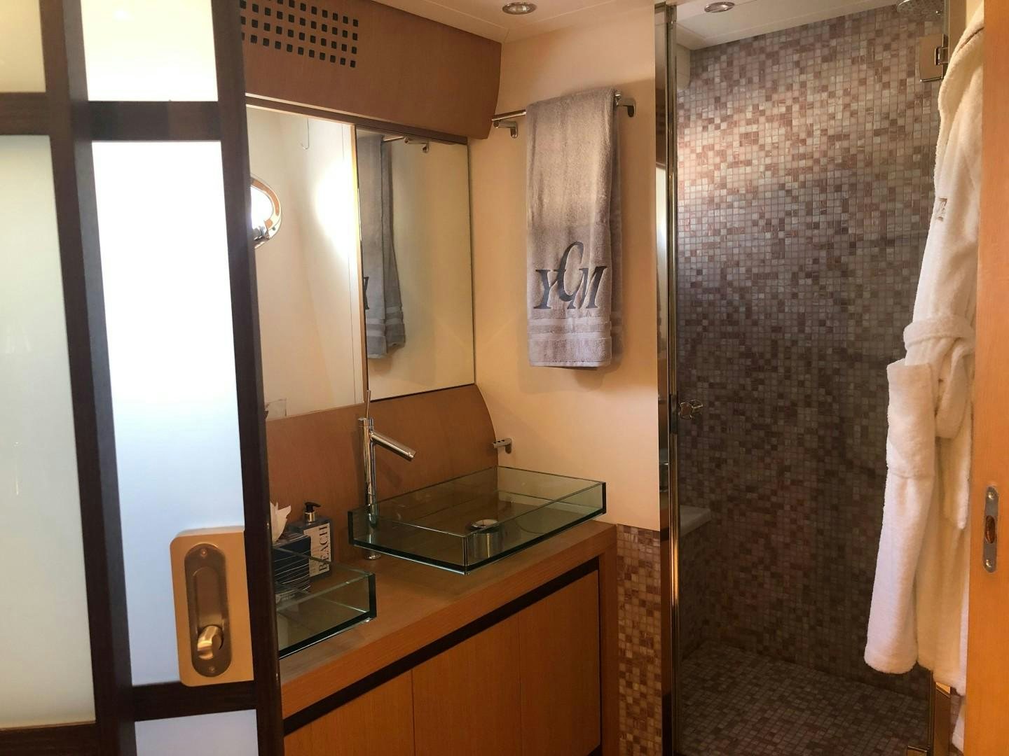a bathroom with a glass shower aboard YCM 90 Yacht for Sale