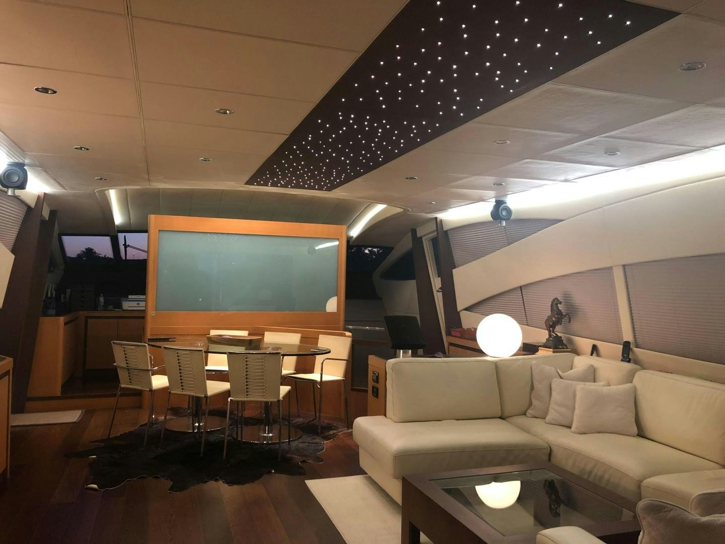 a room with a couch and a tv on the wall aboard YCM 90 Yacht for Sale