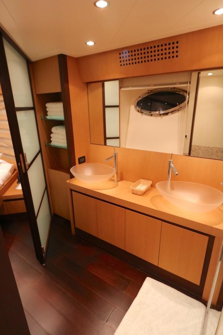 a bathroom with sinks and mirrors aboard YCM 90 Yacht for Sale