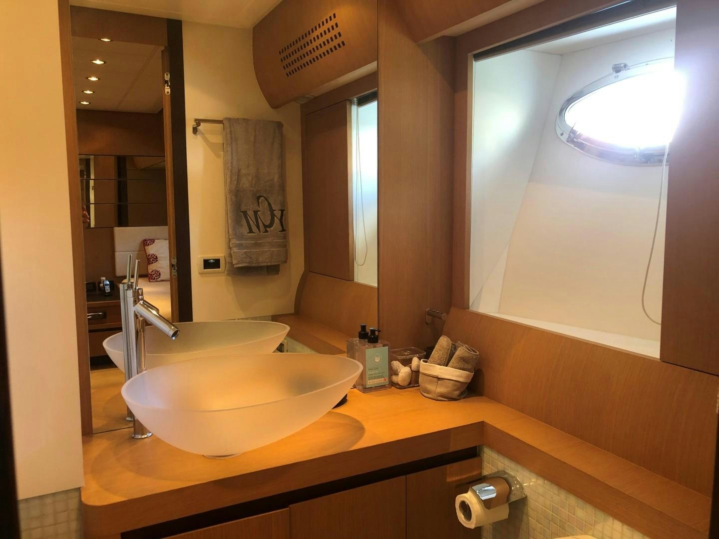 a bathroom with a large mirror aboard YCM 90 Yacht for Sale
