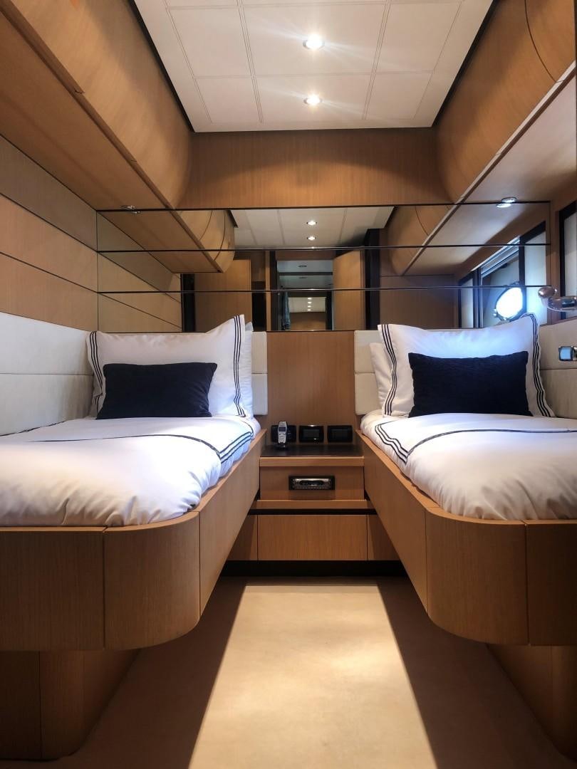a room with beds and a window aboard YCM 90 Yacht for Sale