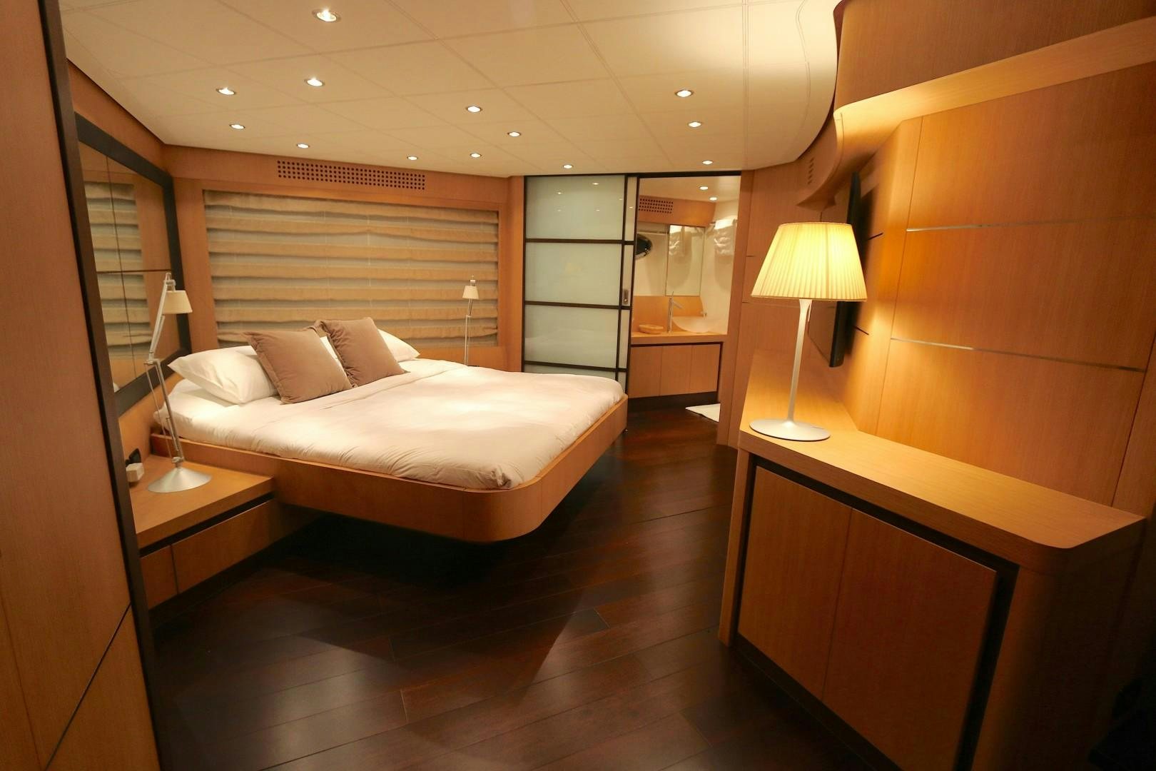 a hotel room with a bed and a desk aboard YCM 90 Yacht for Sale