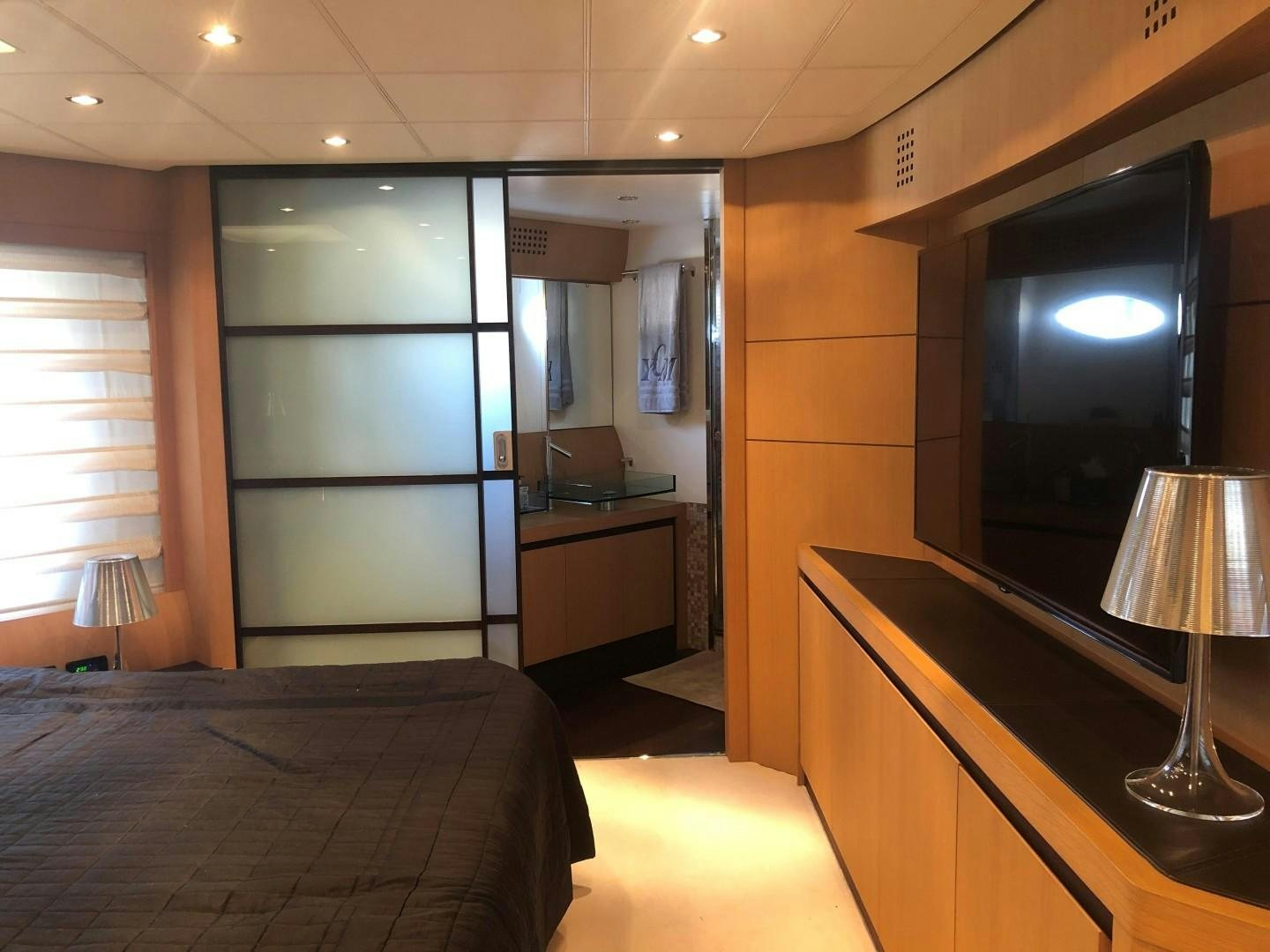 a room with a bed and a tv aboard YCM 90 Yacht for Sale