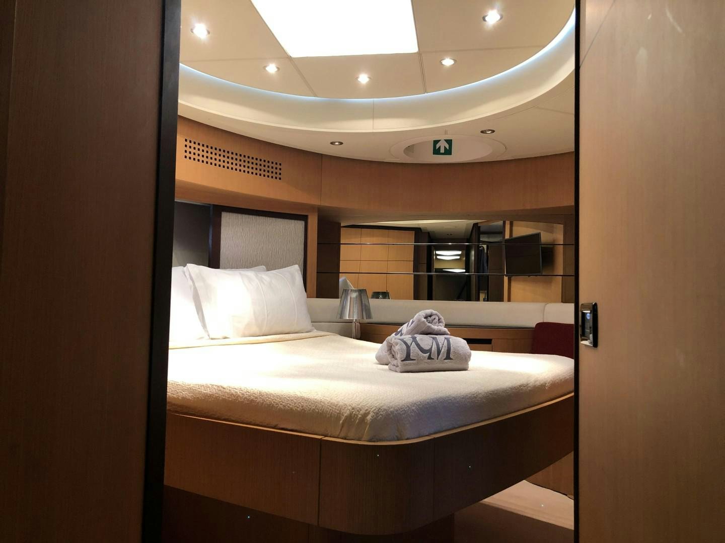 a mirror showing a bed aboard YCM 90 Yacht for Sale