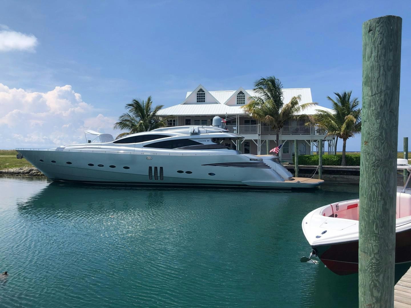 a couple of boats sit in a harbor aboard YCM 90 Yacht for Sale