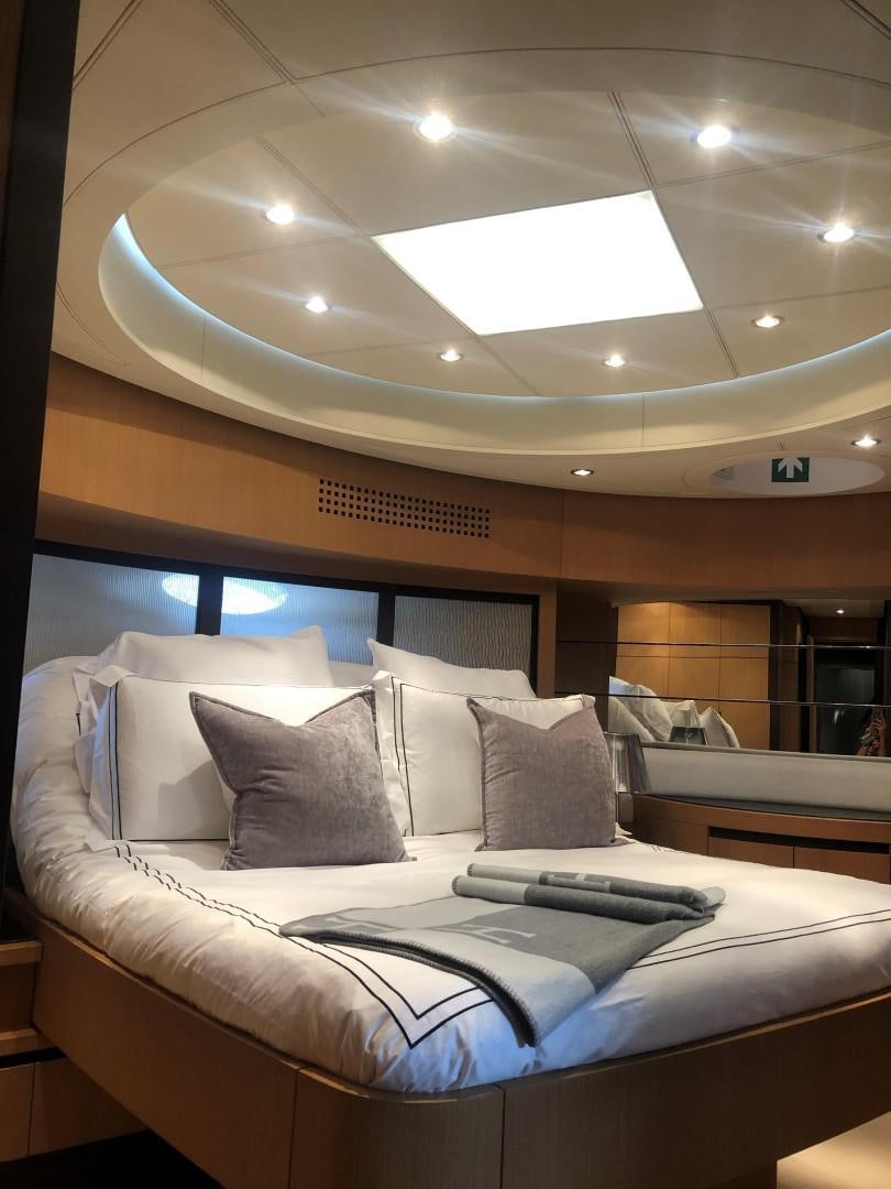 a bed with a white pillow aboard YCM 90 Yacht for Sale