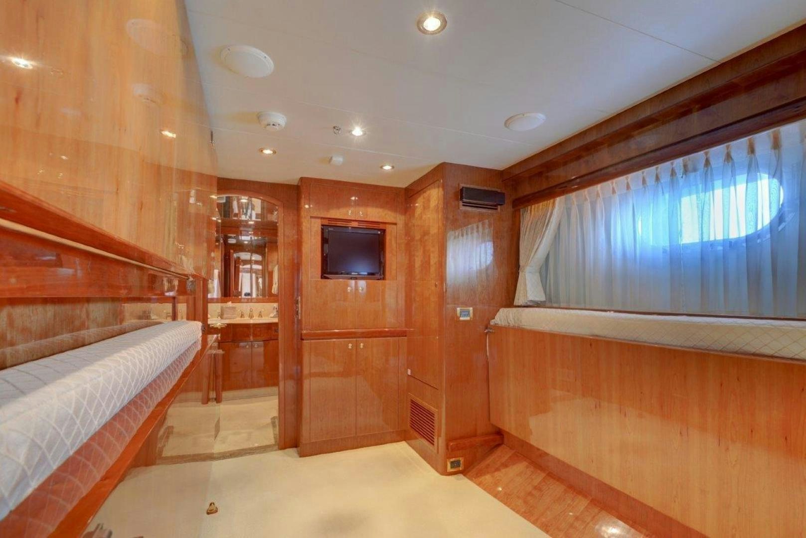 a room with a bed and a television aboard TEE TIME Yacht for Sale