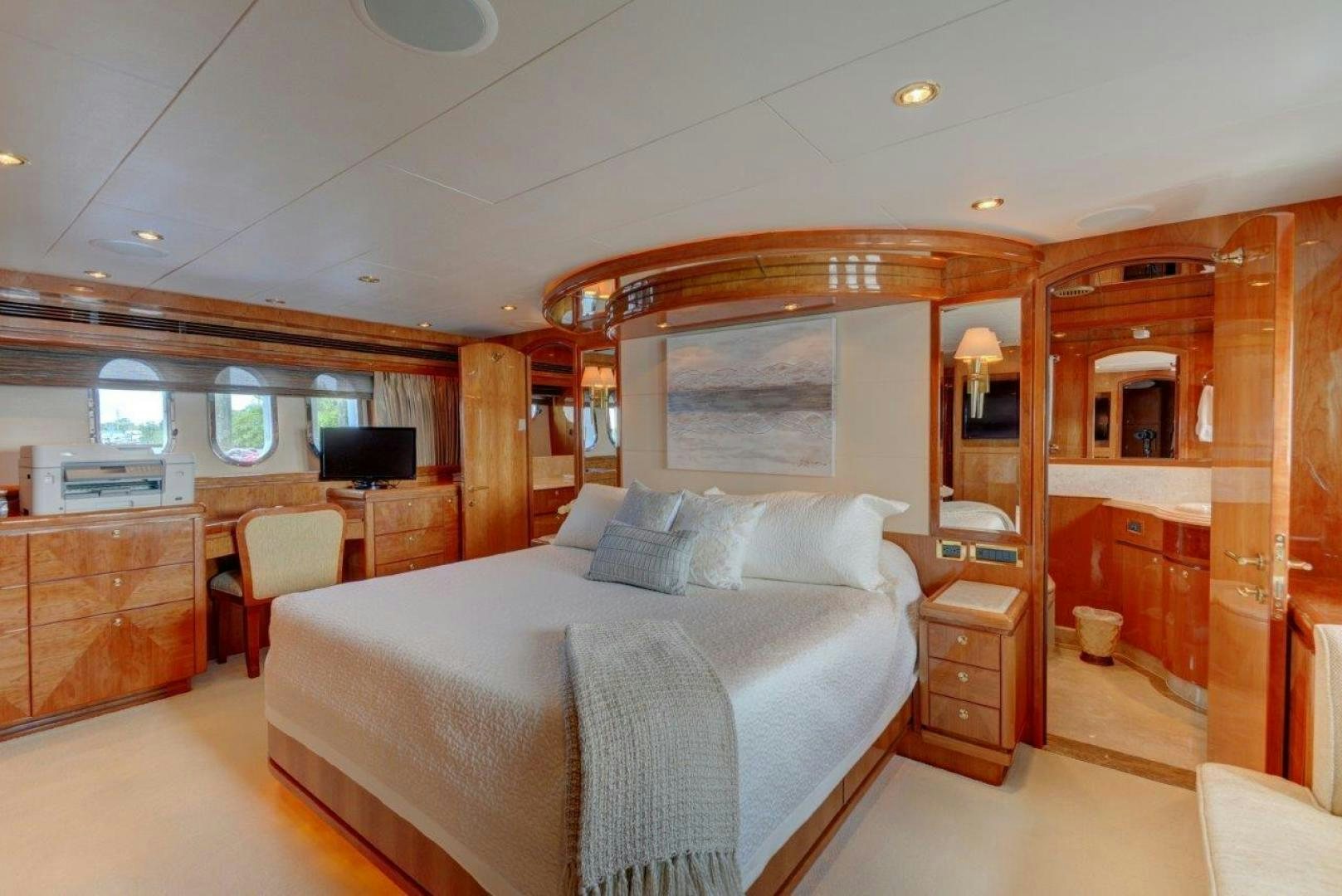 a bedroom with a bed and a desk aboard TEE TIME Yacht for Sale