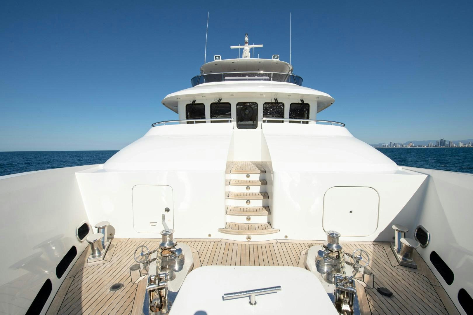 a white boat with a cross on the front aboard LITTLE BLUE Yacht for Sale