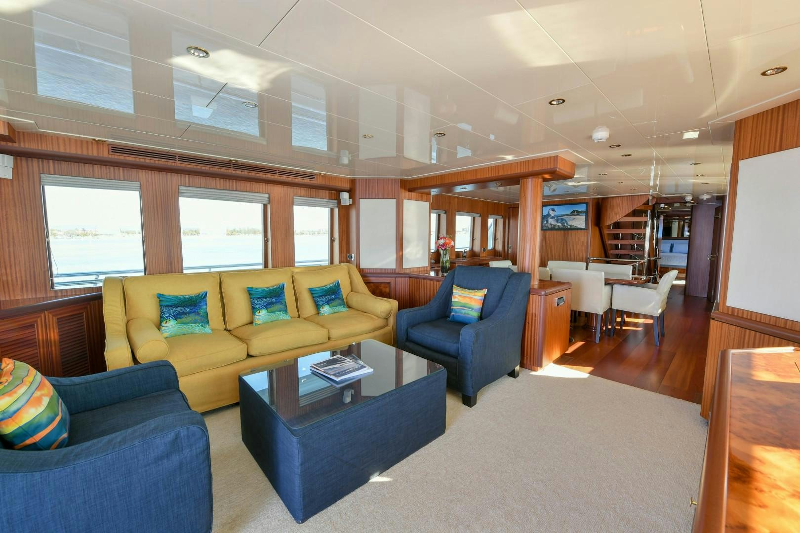 a living room with a couch and a table aboard LITTLE BLUE Yacht for Sale