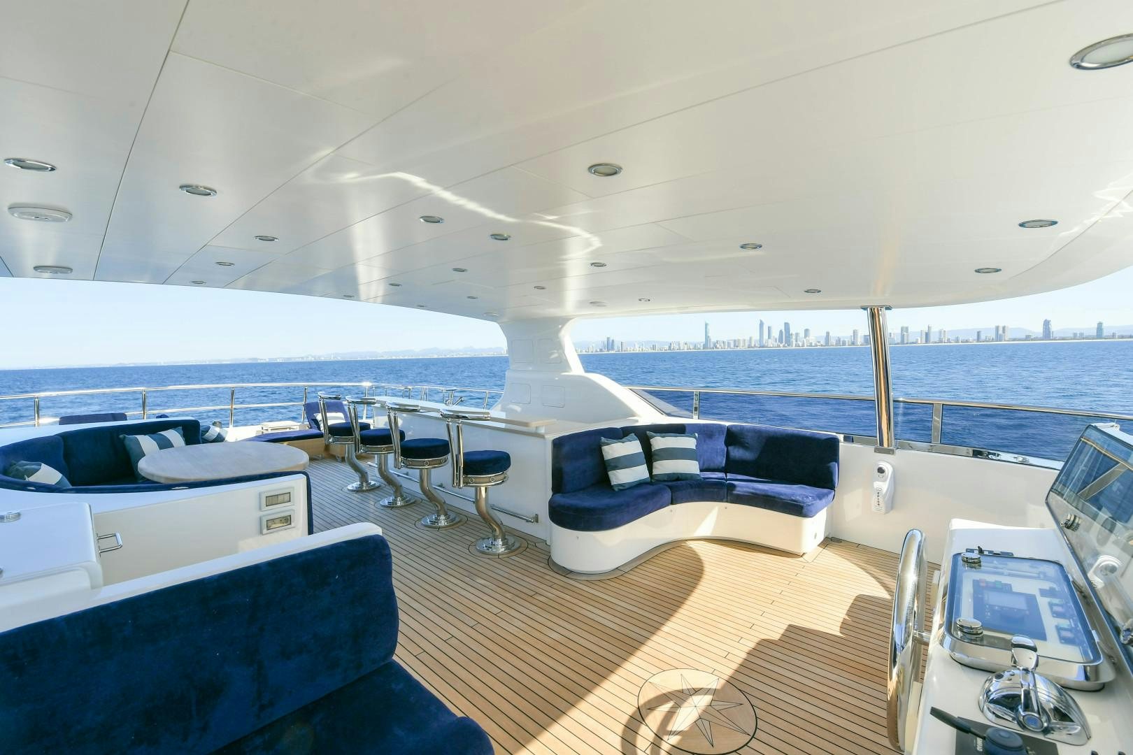 a large cruise ship with chairs and tables aboard LITTLE BLUE Yacht for Sale
