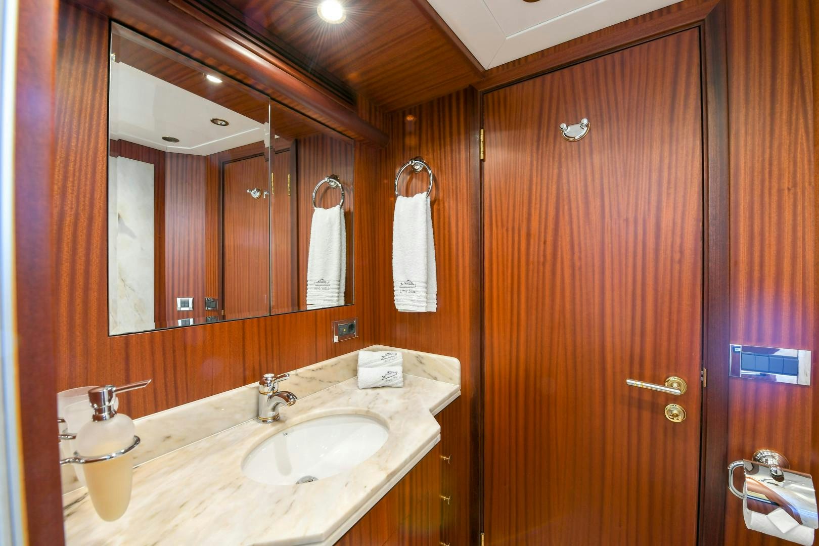 a bathroom with a mirror and a sink aboard LITTLE BLUE Yacht for Sale