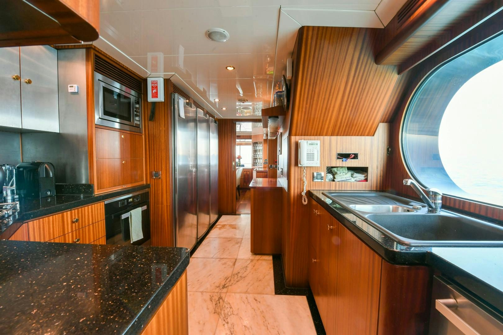 a kitchen with a large island aboard LITTLE BLUE Yacht for Sale