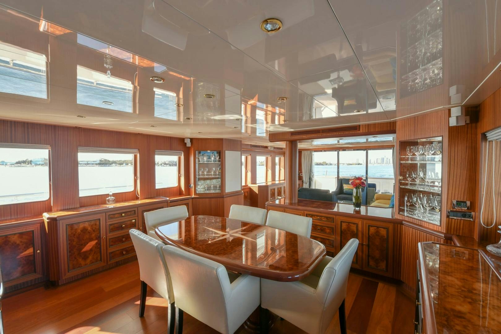 a room with a table chairs and cabinets aboard LITTLE BLUE Yacht for Sale