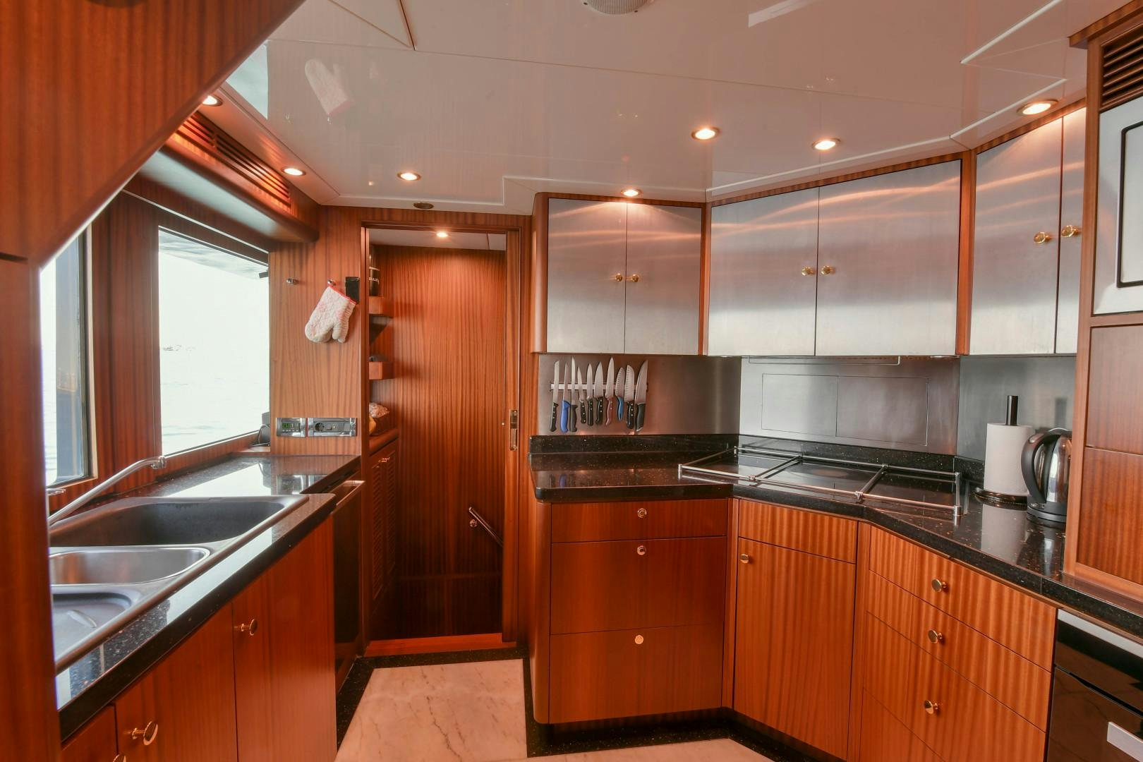 a kitchen with wooden cabinets aboard LITTLE BLUE Yacht for Sale