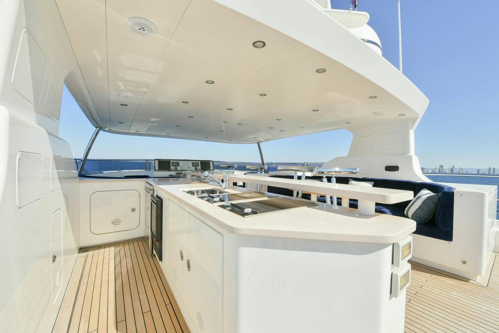 a white kitchen with a large white stove and white cabinets aboard LITTLE BLUE Yacht for Sale
