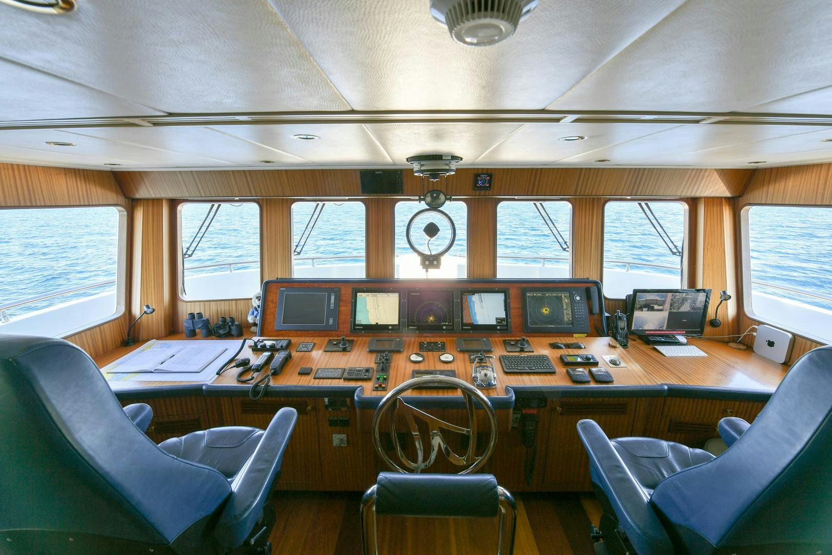 a control room with a table and chairs aboard LITTLE BLUE Yacht for Sale