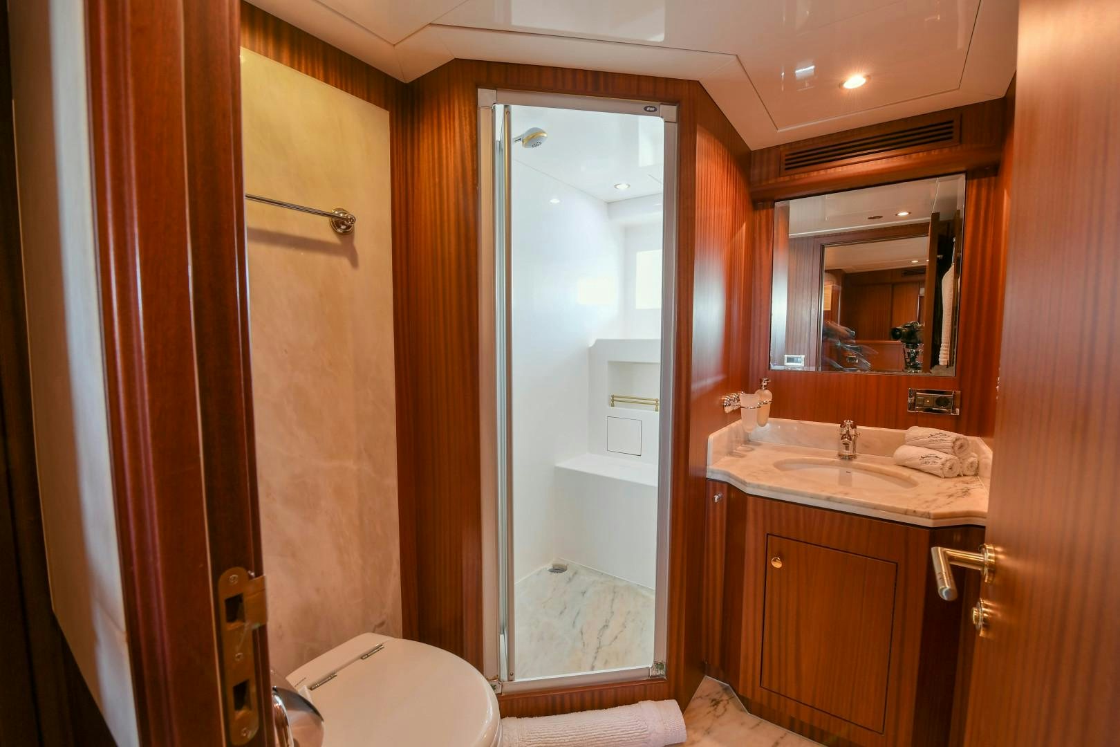 a bathroom with a glass shower door aboard LITTLE BLUE Yacht for Sale
