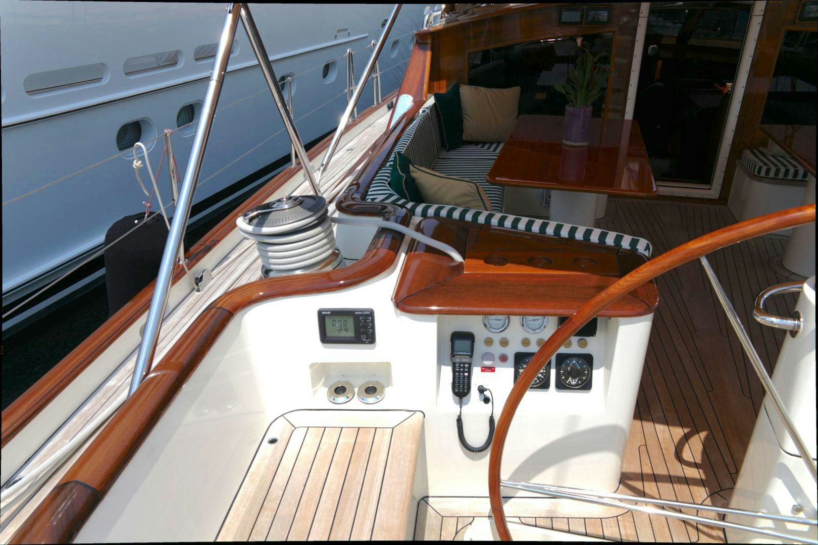 a wooden boat with a wood steering wheel and a wood steering wheel aboard WHIRLWIND Yacht for Sale
