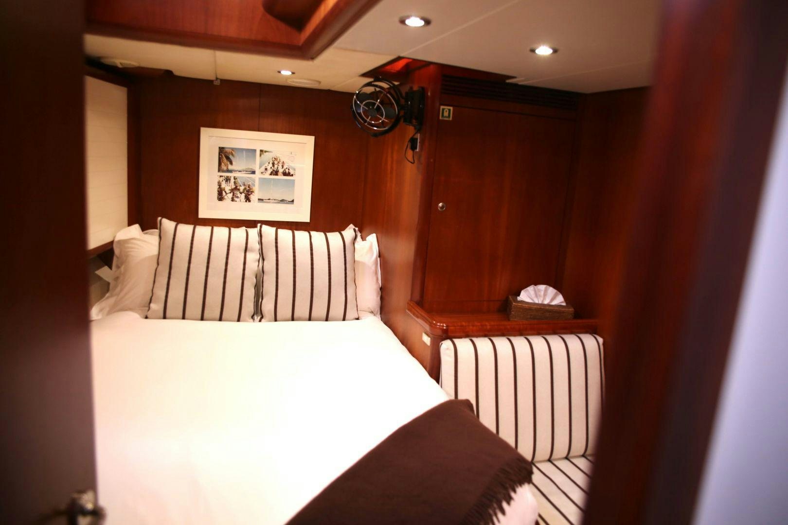 a bed with a white sheet aboard WHIRLWIND Yacht for Sale
