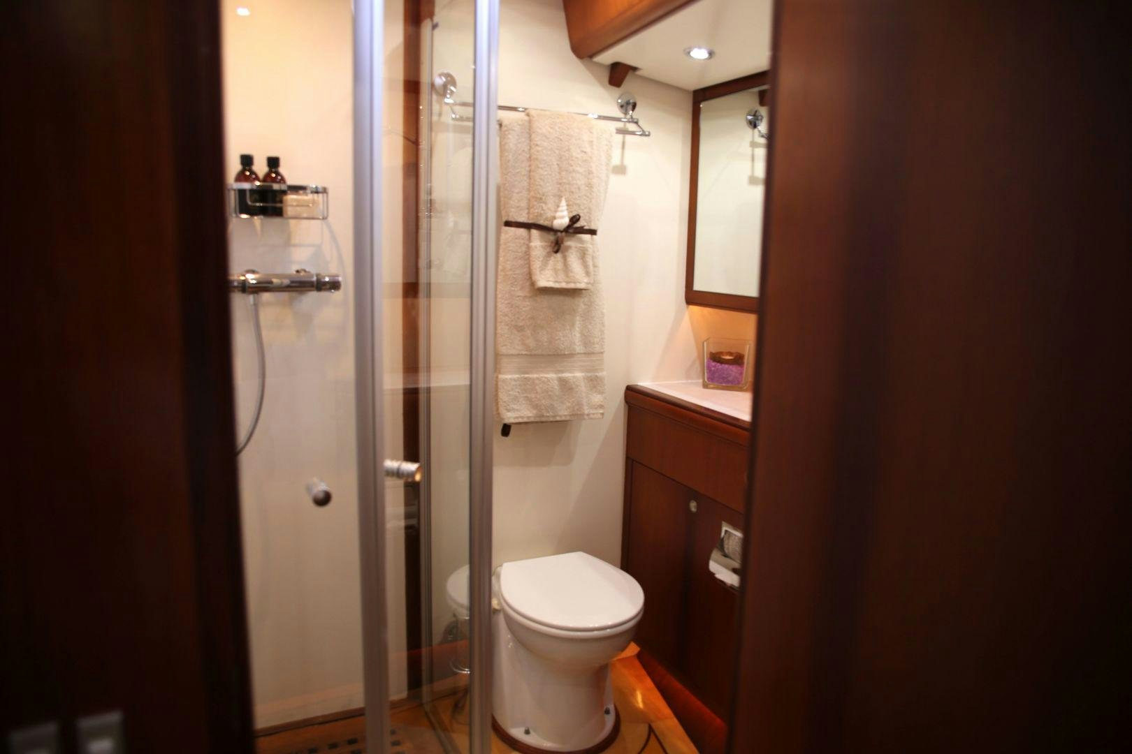 a bathroom with a glass shower aboard WHIRLWIND Yacht for Sale