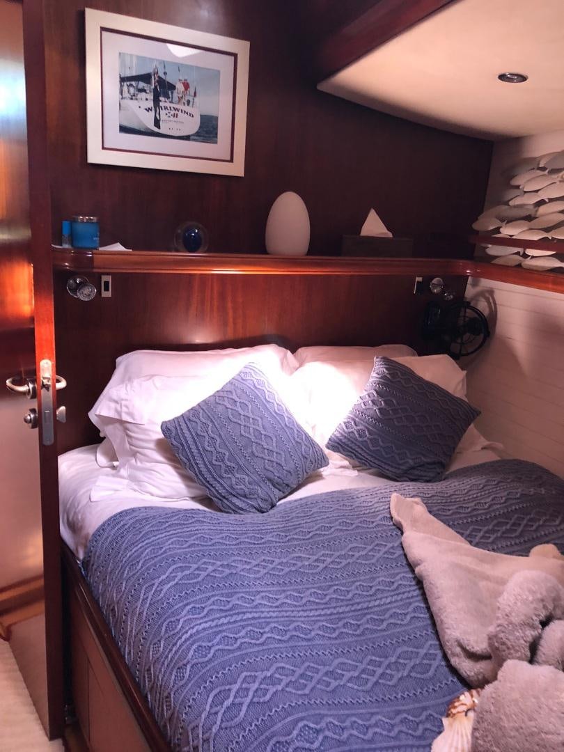 a bed with white sheets and pillows aboard WHIRLWIND Yacht for Sale