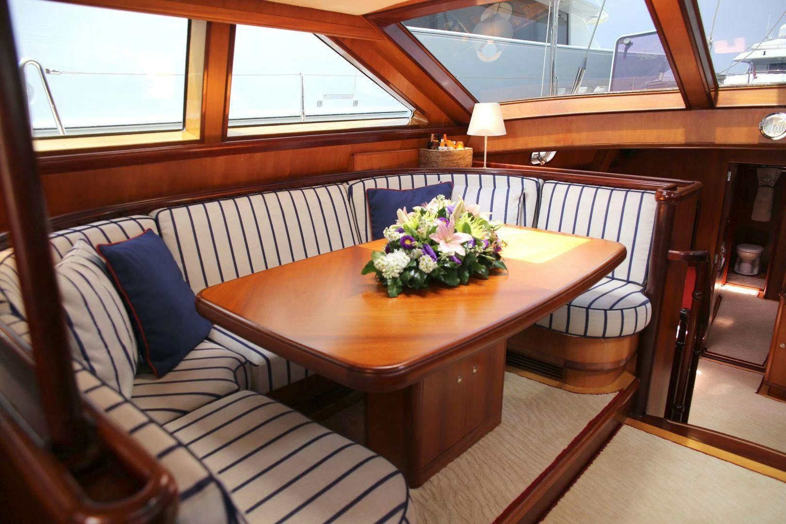a table with a vase of flowers on it aboard WHIRLWIND Yacht for Sale