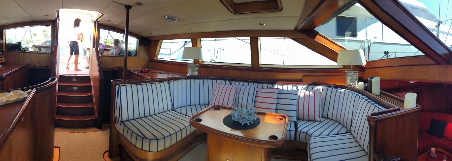 a room with a table and chairs aboard WHIRLWIND Yacht for Sale