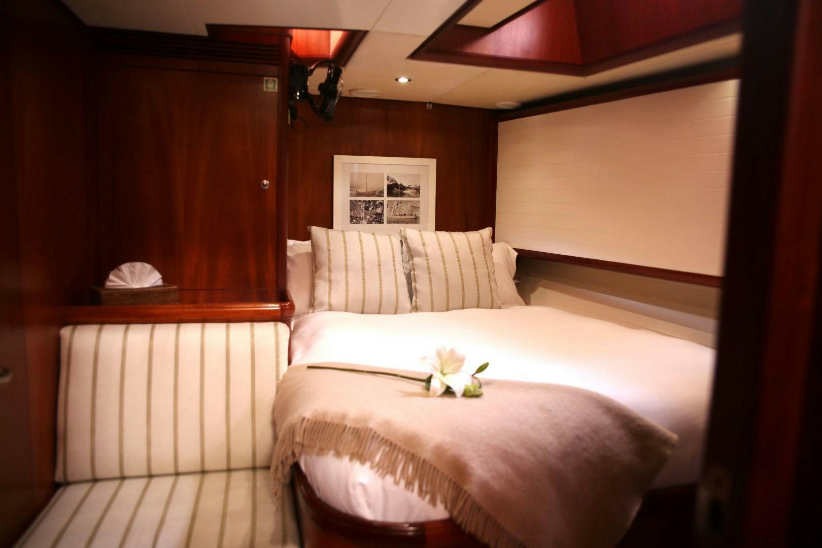 a room with a bed and a table aboard WHIRLWIND Yacht for Sale