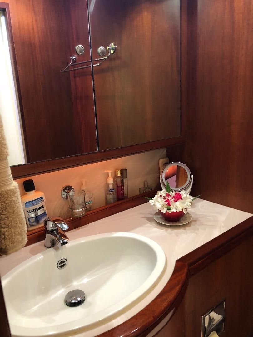 a bathroom sink with a mirror above it aboard WHIRLWIND Yacht for Sale