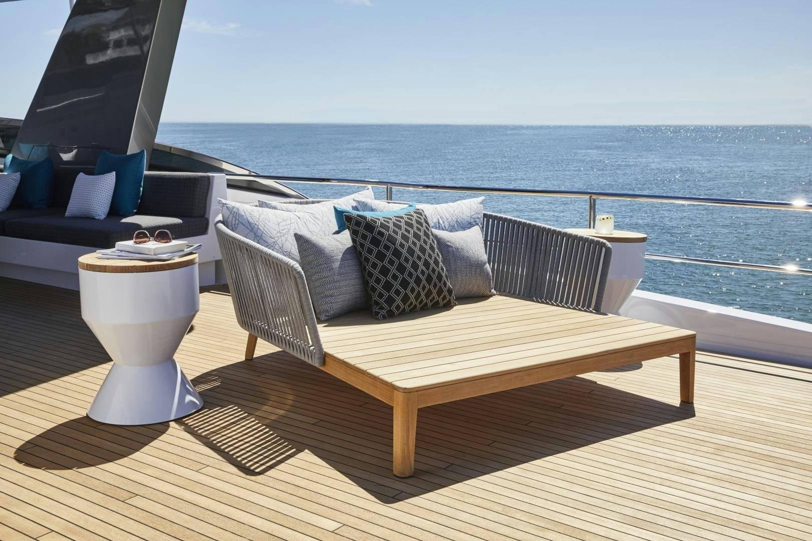 a table with a white coffee cup on it and a large body of water in the background aboard 2021 NEW BUILD Yacht for Sale