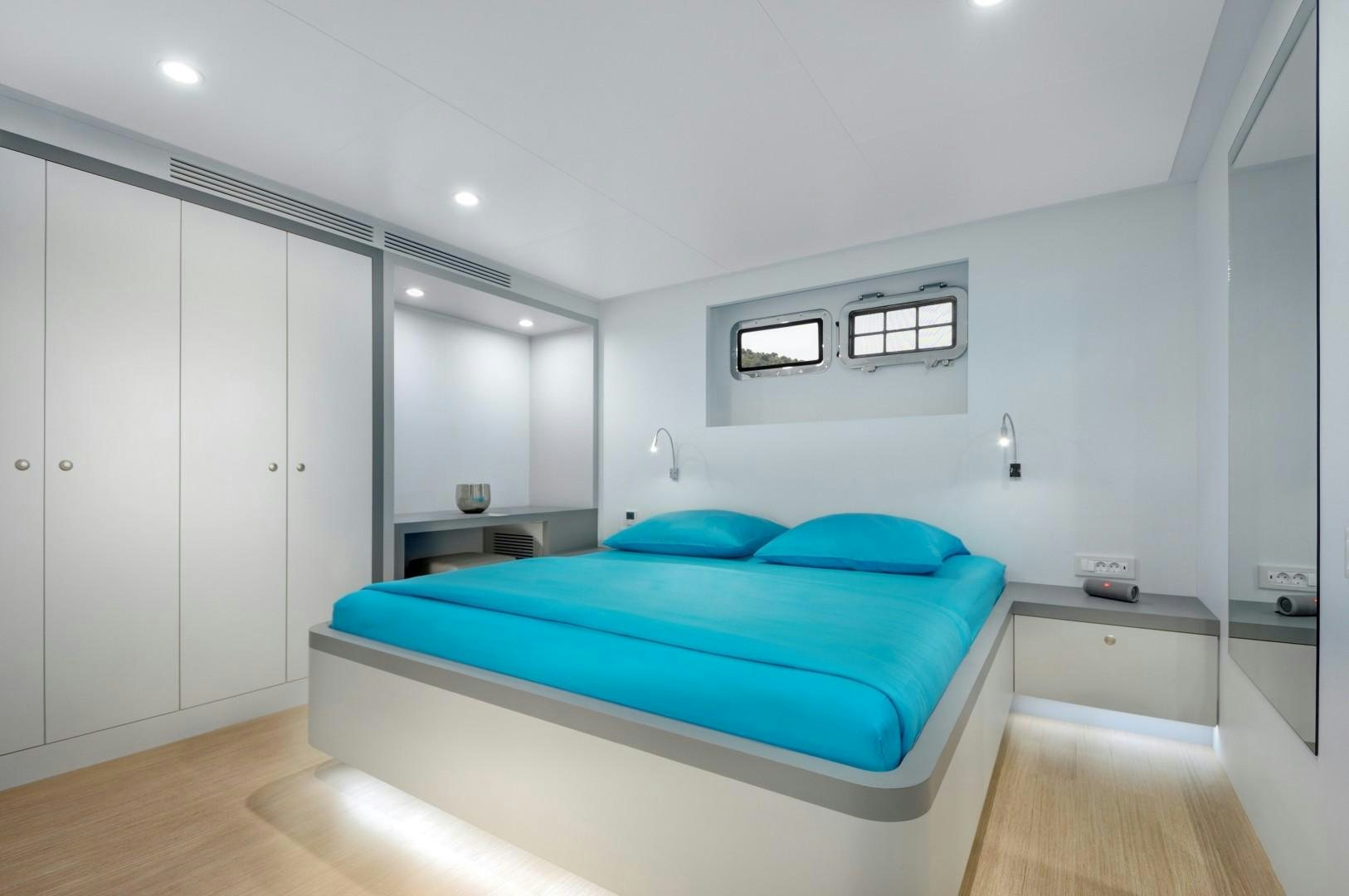a bedroom with a bed aboard BIG JOY Yacht for Sale
