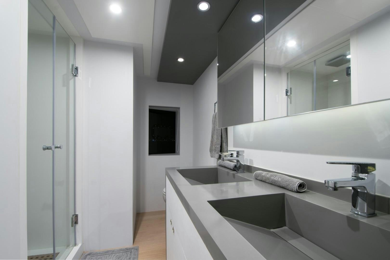 a bathroom with a large mirror aboard BIG JOY Yacht for Sale