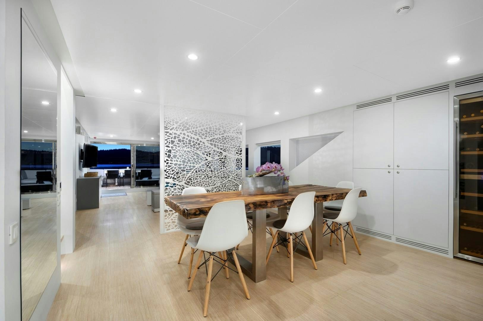 a large kitchen with a table and chairs aboard BIG JOY Yacht for Sale