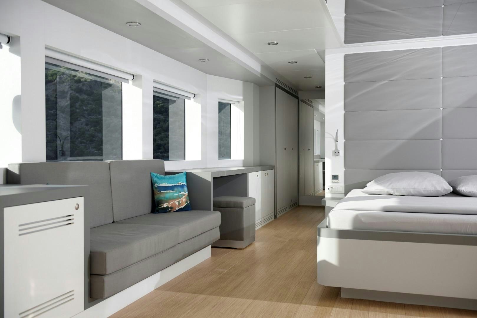 a room with a couch and a bed aboard BIG JOY Yacht for Sale