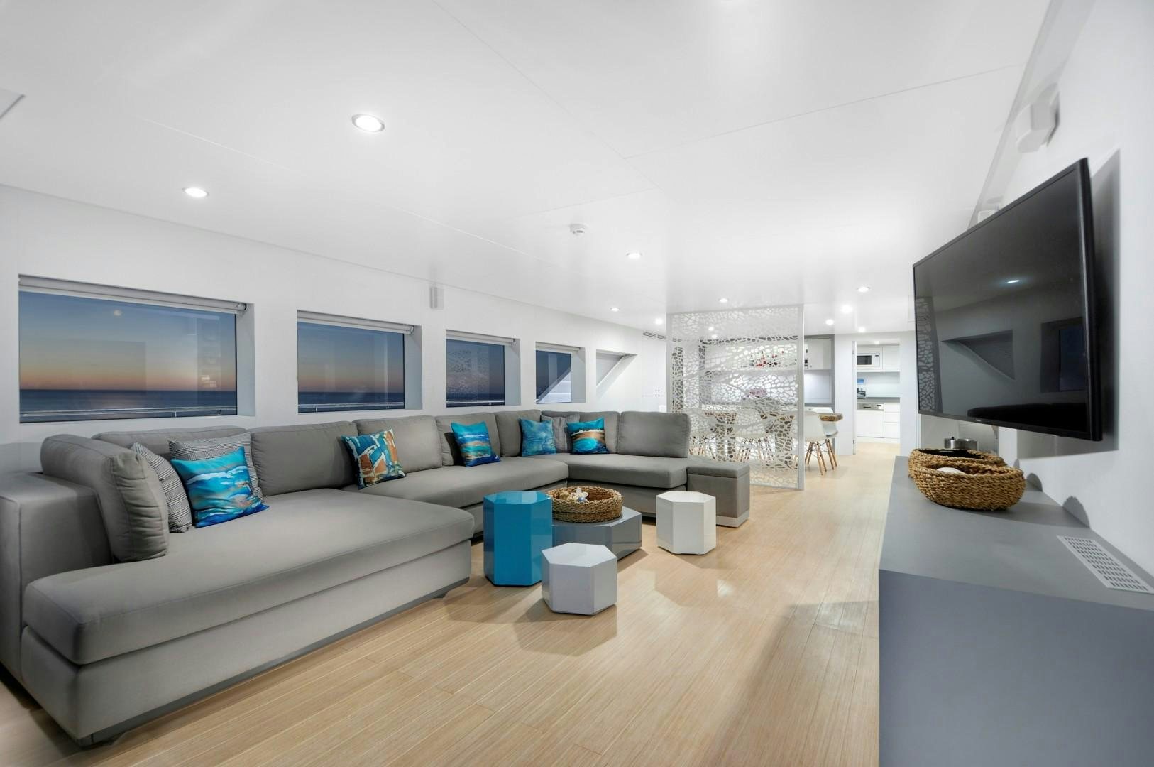 a living room with a large screen aboard BIG JOY Yacht for Sale