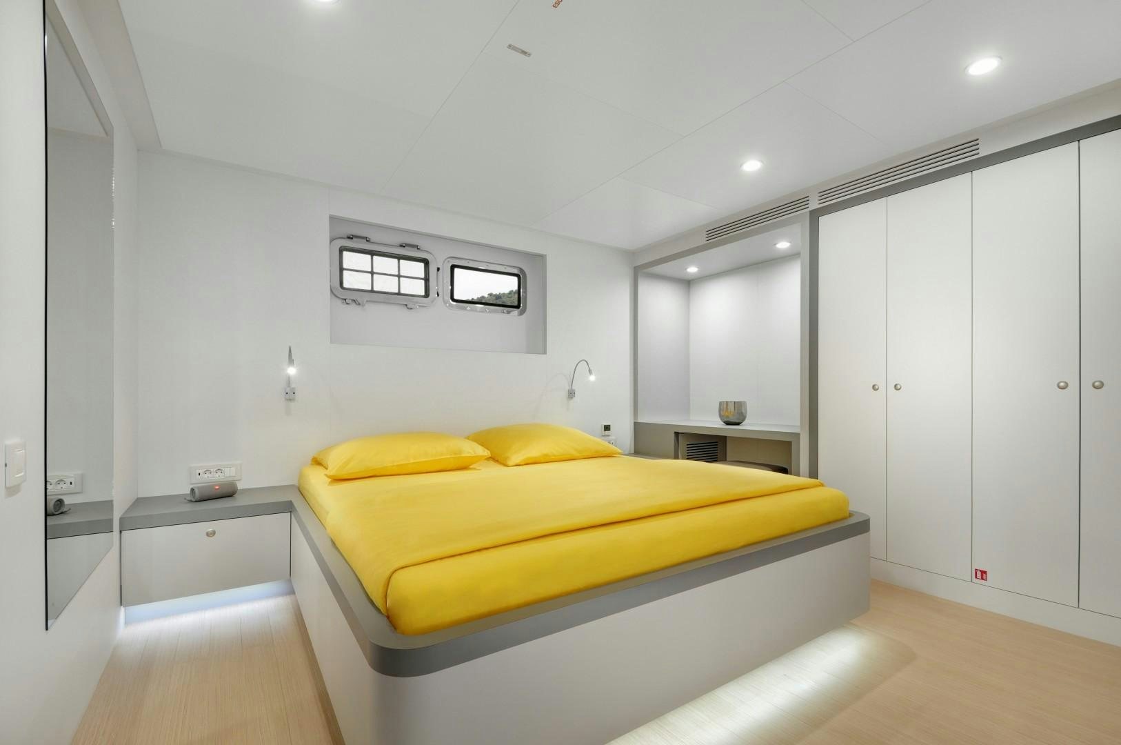 a bedroom with a bed aboard BIG JOY Yacht for Sale