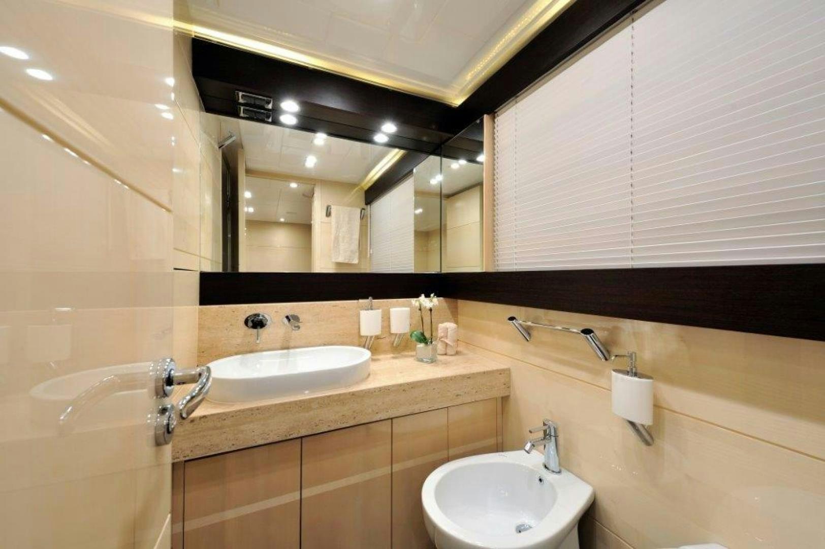 a bathroom with two sinks and a large mirror aboard ELLISIUM Yacht for Sale