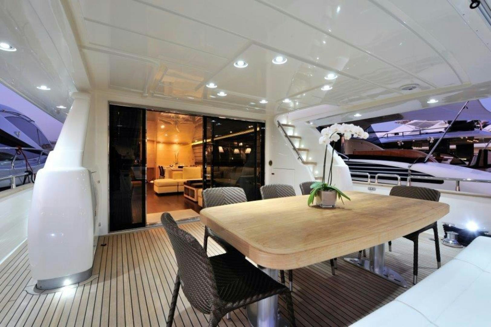 a room with a table chairs and a large window aboard ELLISIUM Yacht for Sale