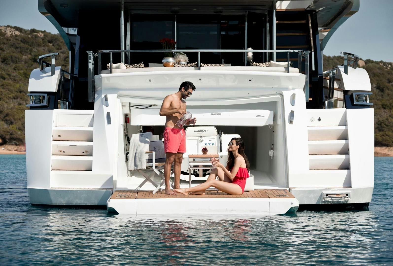 a man and woman standing on a boat in the water aboard KALLIENTE Yacht for Sale