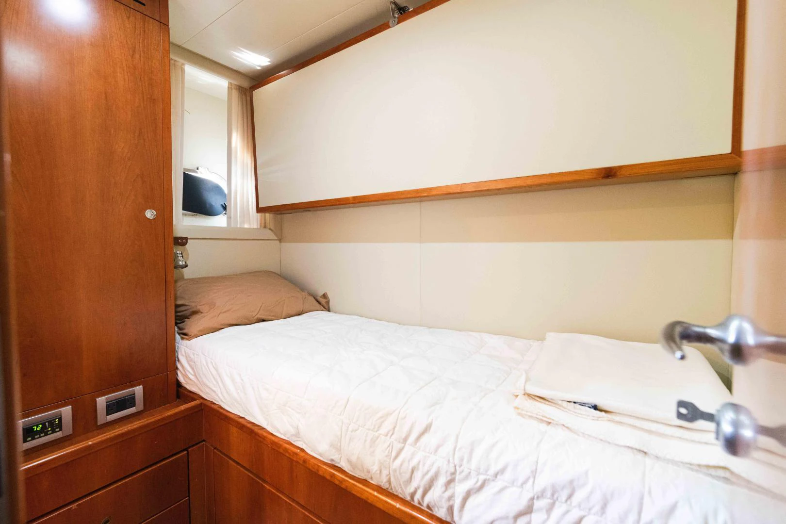 a bed with a white sheet and a white towel on it aboard KAVITA Yacht for Sale